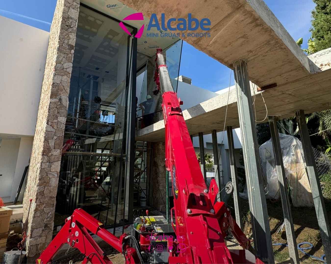 Alquiler de mini grúa en Marbella para la colocación de vidrios en un chalet de lujo.